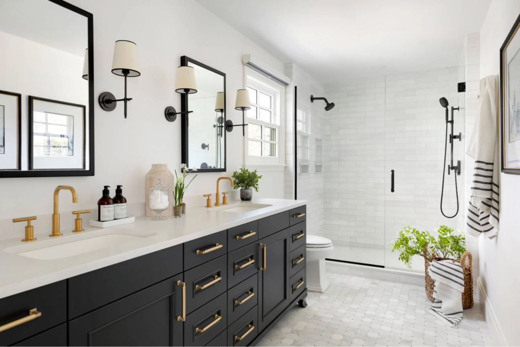 Modern bathroom with soft white walls, crisp white trim and black matte cabinets by an interior painter in Vero Beach, FL.