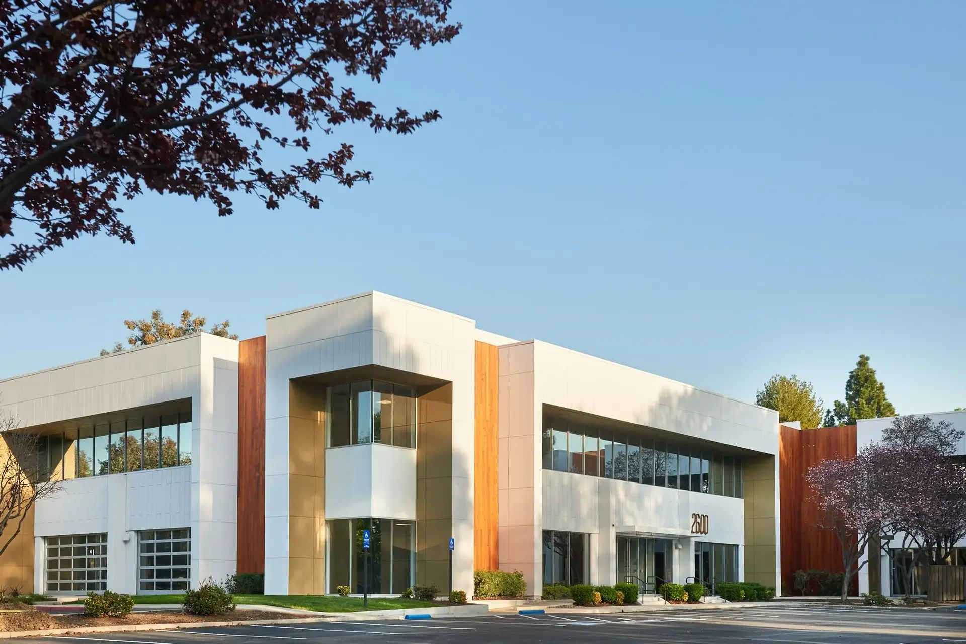 Office building with white exterior finishes, wood accent panels, and clean trim details by an exterior painter in Sebastian, FL