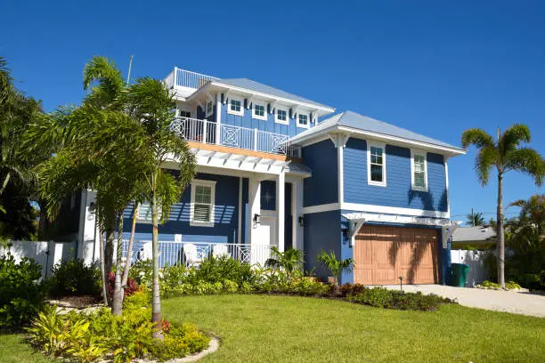 Blue home with crisp white trim and detailed exterior paint finishes by a house painter in Fellsmere, FL.