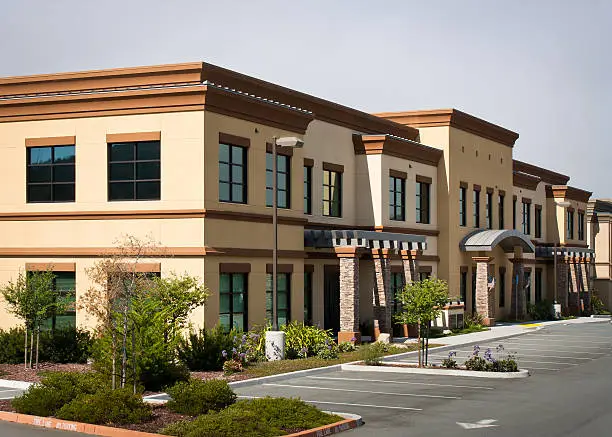 Commercial building with warm neutral exterior colors and architectural details by an exterior painter in Bent Pine, FL.