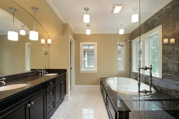 Bathroom with warm beige wall color, white trim, and dark cabinetry by a house painter in Sebastian Inlet, FL.